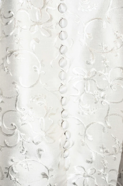 a close up of a dress on a mannequin mannequin mannequin mannequin mannequin mannequin manne, inspired by Master of the Embroidered Foliage, reddit, baroque, in a flowing white tailcoat, detail texture, circa 1940s, satin silver