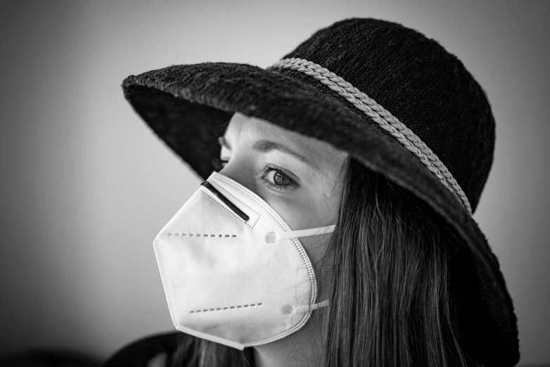 a woman wearing a hat and a face mask, a black and white photo, pixabay, portrait image, coronavirus, environmental portrait, portrait n - 9
