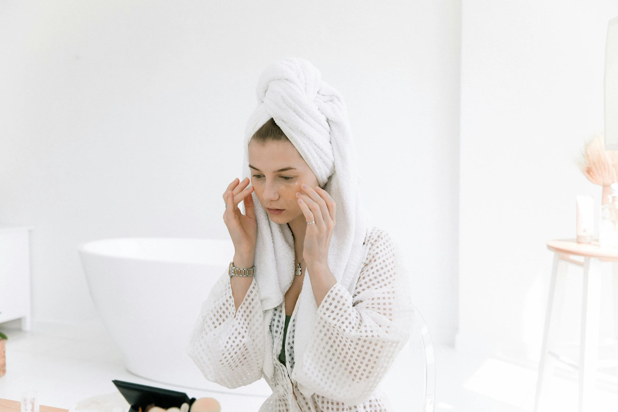 a woman in a bathrobe wiping her face with a towel, a picture, trending on pexels, on a white table, square facial structure, gif, face picture