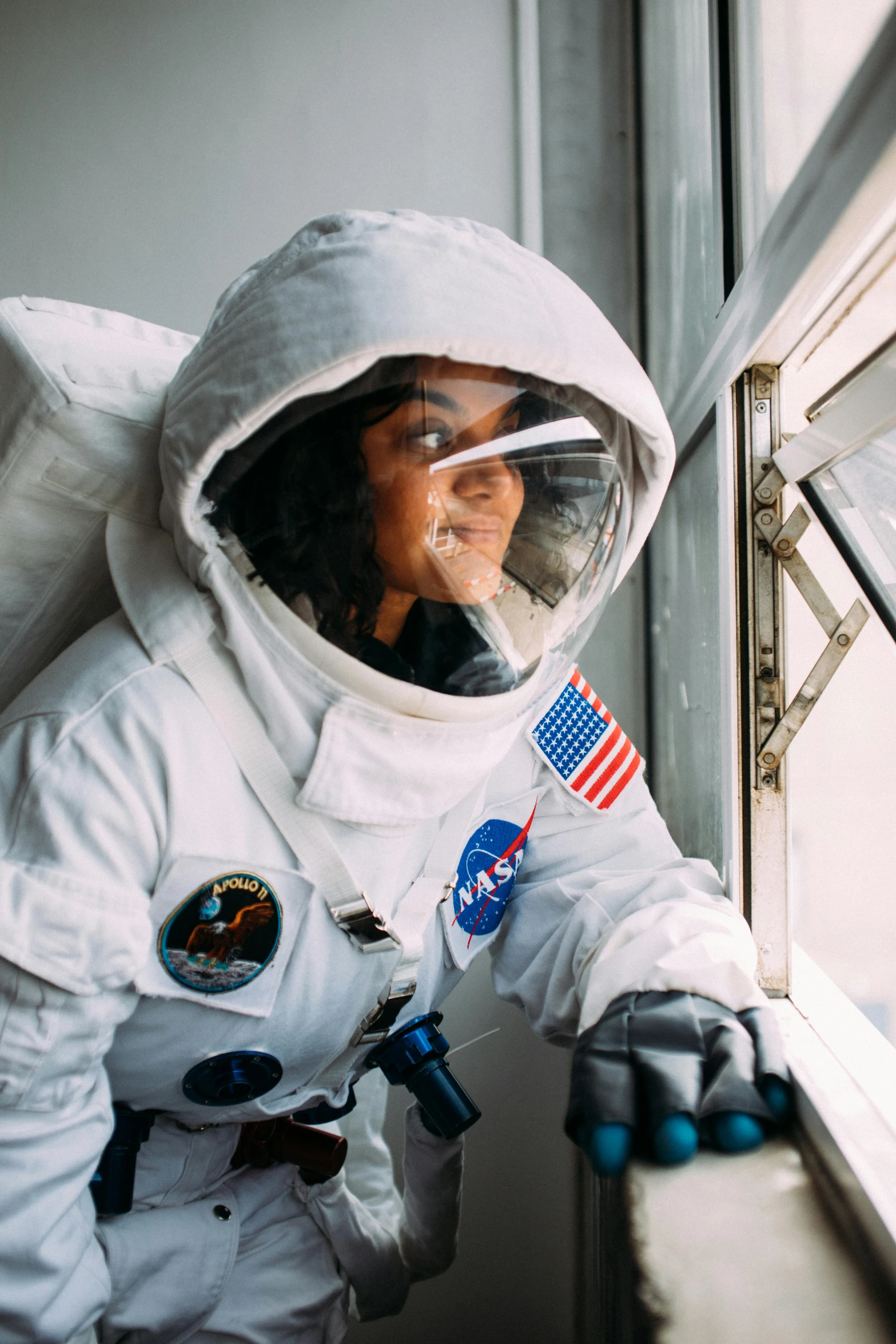 a man in a spacesuit looking out a window, girl wearing uniform, wearing adventure gear, fully covered, wearing lab coat and a blouse