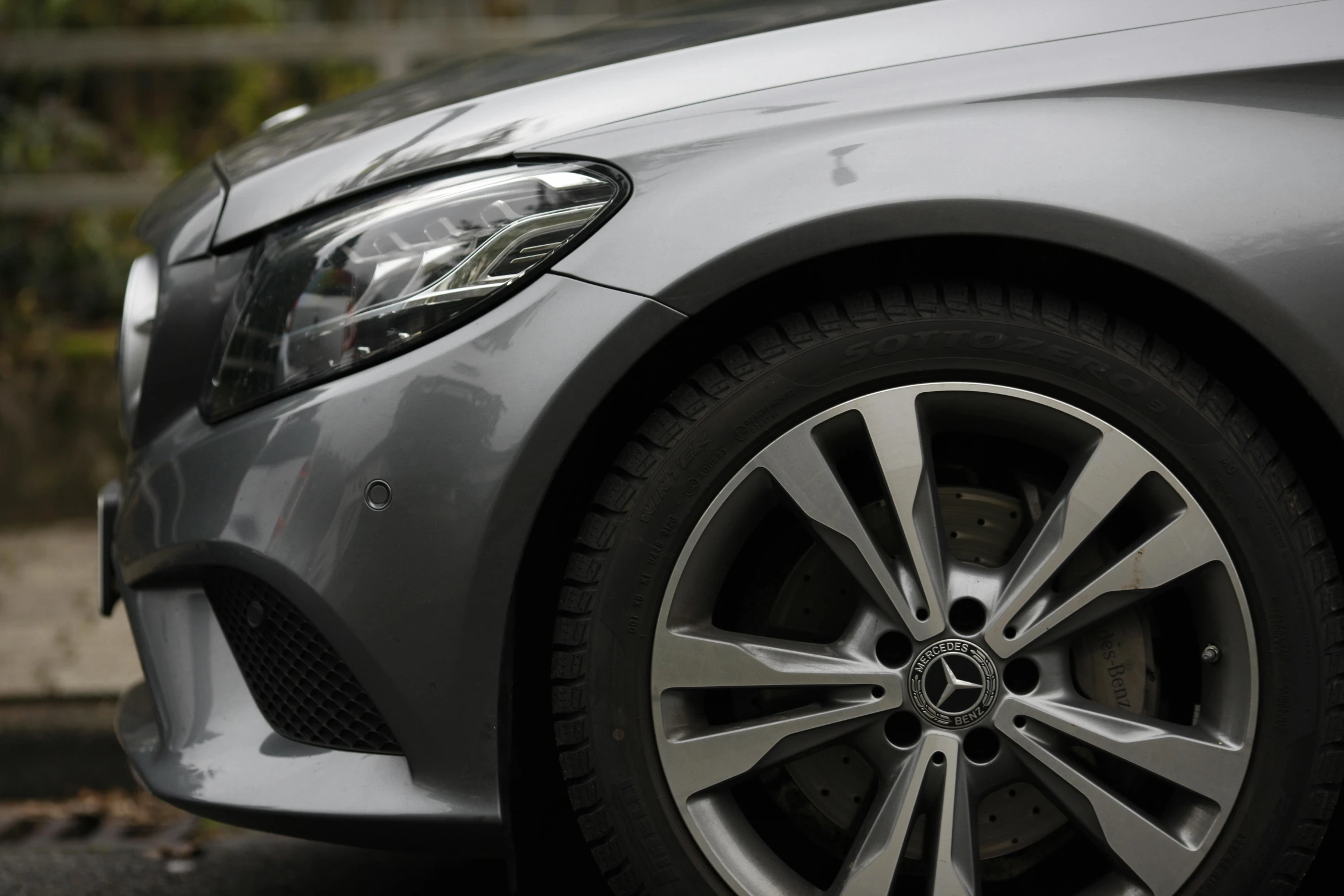 a car parked on the side of the road, detailed alloy wheels, photographed for reuters, mercedez benz, medium close - up ( mcu )