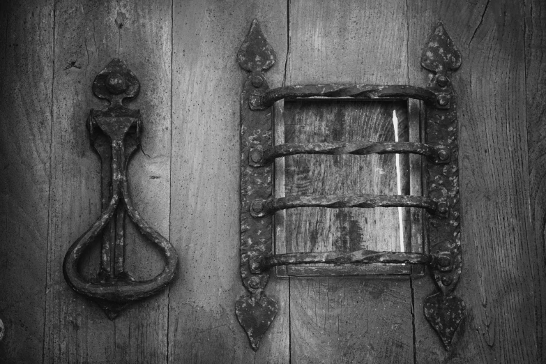 a black and white photo of a door and a window, symbolism, hammer and sickles, made of intricate metal and wood, carson ellis, rustic