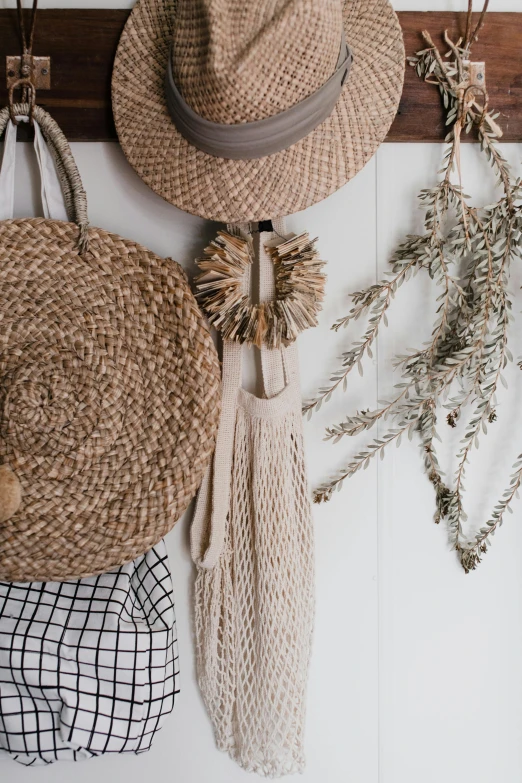 a bunch of hats hanging on a wall, by Elizabeth Durack, trending on pexels, natural materials :: high detail, in a white boho style studio, bags, harvest