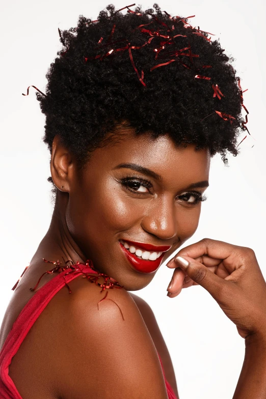 a woman in a red dress posing for a picture, by Lily Delissa Joseph, black dynamic hair, holiday, promo photo, curly pixie hair