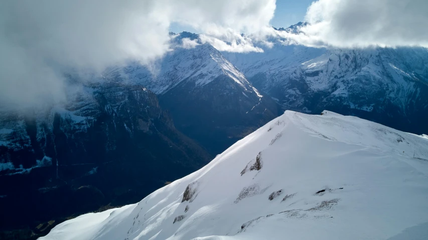 a person standing on top of a snow covered mountain, les nabis, nature photo