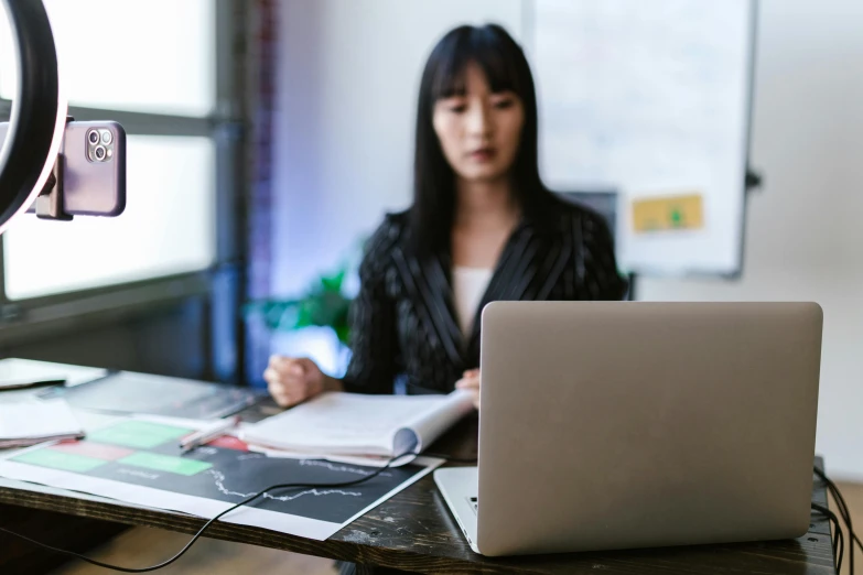 a woman sitting at a desk in front of a laptop computer, trending on pexels, asian female, professional detailed photo, thumbnail