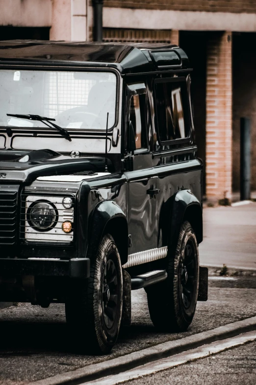 a black land rover parked on the side of the road, pexels contest winner, renaissance, high technical detail, low quality photo, land rover defender 110 (1985), modern