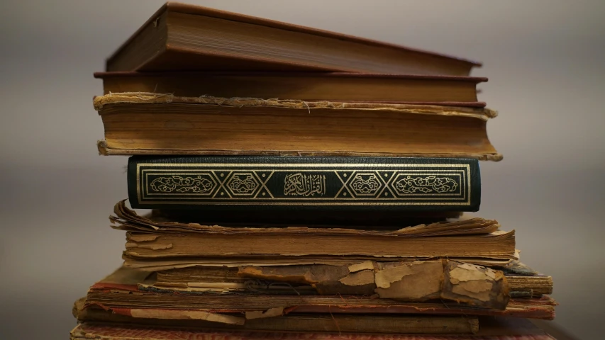 a stack of books sitting on top of each other, hurufiyya, intricate engraving, black, medium - shot, middle eastern