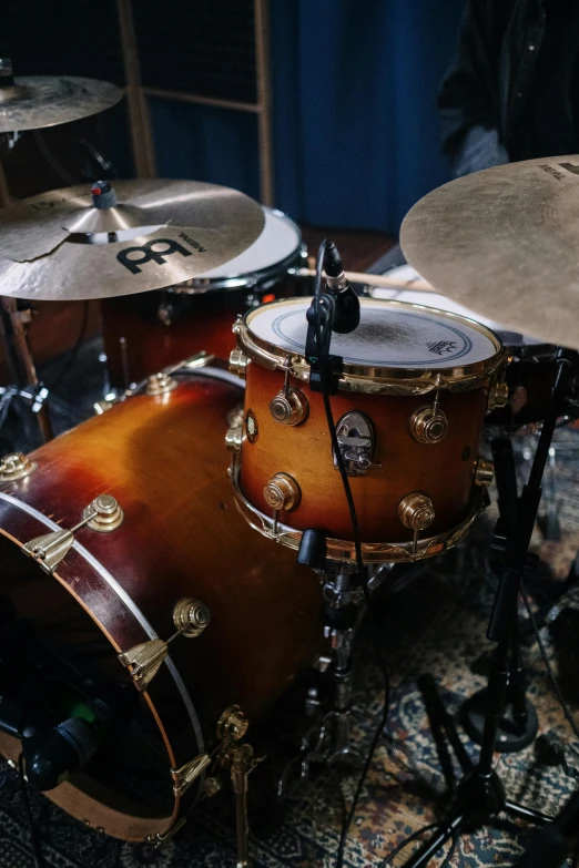 a close up of a drum set in a room, by Leo Michelson, featured on reddit, photorealism, promo image, eastman color, caramel, and