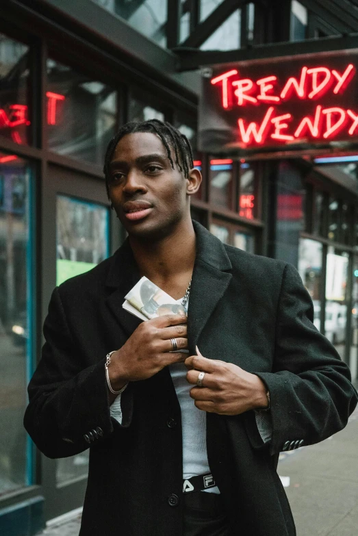 a man standing in front of a store holding money, an album cover, by Stokely Webster, pexels contest winner, playboi carti portrait, actor, business attire, smug look