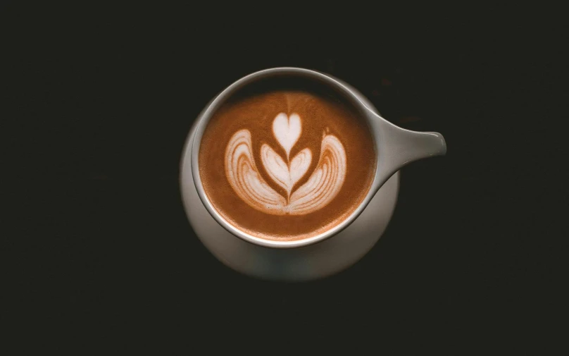 a cup of coffee sitting on top of a table, latte art, dark and intricate, high quality product image”, short spout