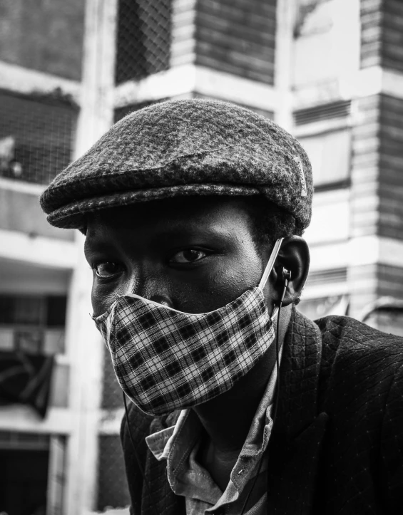 a black and white photo of a man wearing a face mask, a black and white photo, unsplash contest winner, afrofuturism, unmistakably kenyan, ghetto, dapper, teenage boy