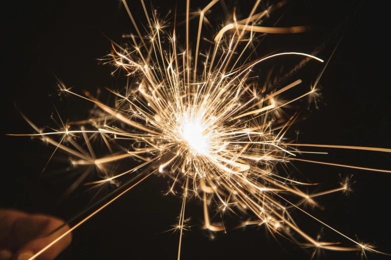 a person holding a sparkler in their hand, pexels, magnesium, getty images, thumbnail, shiny golden