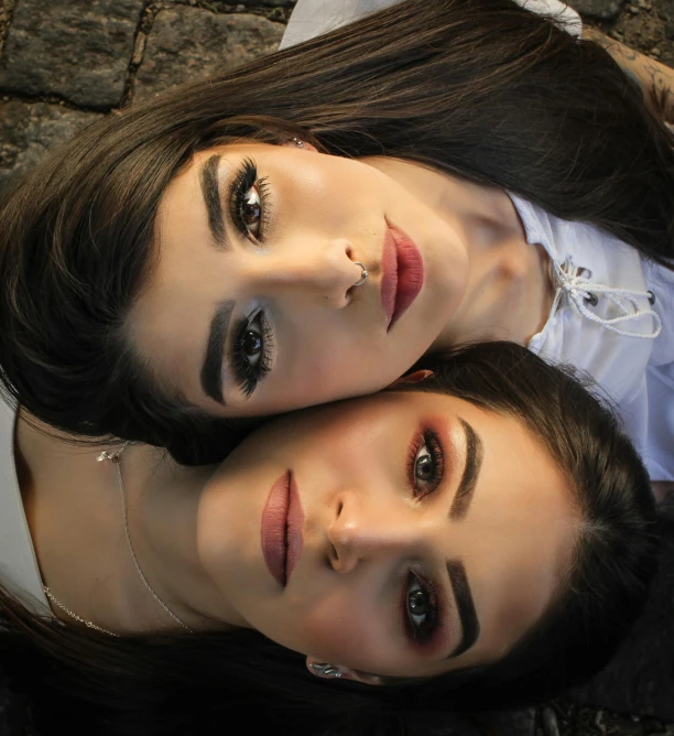 a couple of women laying on top of each other, pexels contest winner, hyperrealism, gothic makeup, avatar image, identical eyes, middle eastern skin