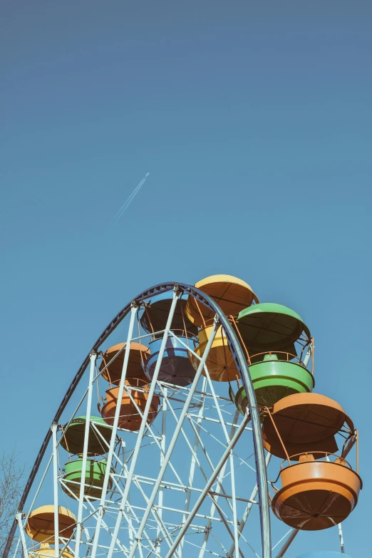 a ferris wheel in front of a blue sky, rocket ship, vibrant muted colors, 15081959 21121991 01012000 4k, jc park