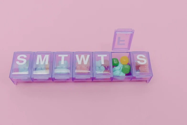 the word smtwits spelled in plastic letters on a pink background, an album cover, by Amelia Peláez, trending on pexels, antipodeans, pills, purple tubes, bt 2 1, minimalist photorealist