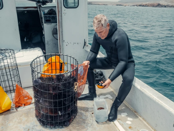 a man in a wet suit is on a boat, covered in coral and barnacles, wearing a fisher 🧥, sitting on top of a cryopod, brown