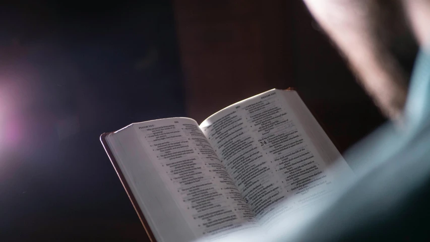 a man is reading a book in the dark, pexels, unilalianism, with god blushing, standing inside of a church, word, list