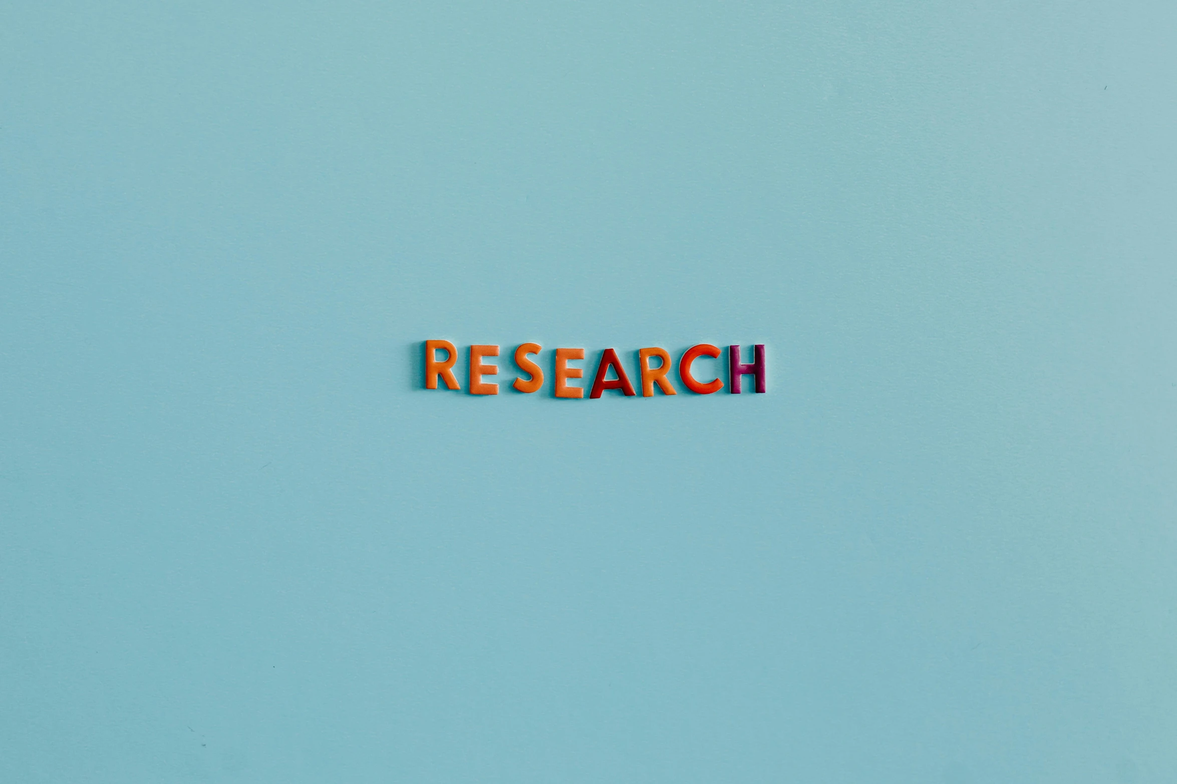 a blue wall with the word research written on it, an album cover, trending on unsplash, mauve and cinnabar and cyan, hr ginger, miniature product photo, colorful picture