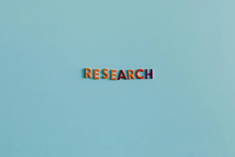 a blue wall with the word research written on it, an album cover, trending on unsplash, mauve and cinnabar and cyan, hr ginger, miniature product photo, colorful picture