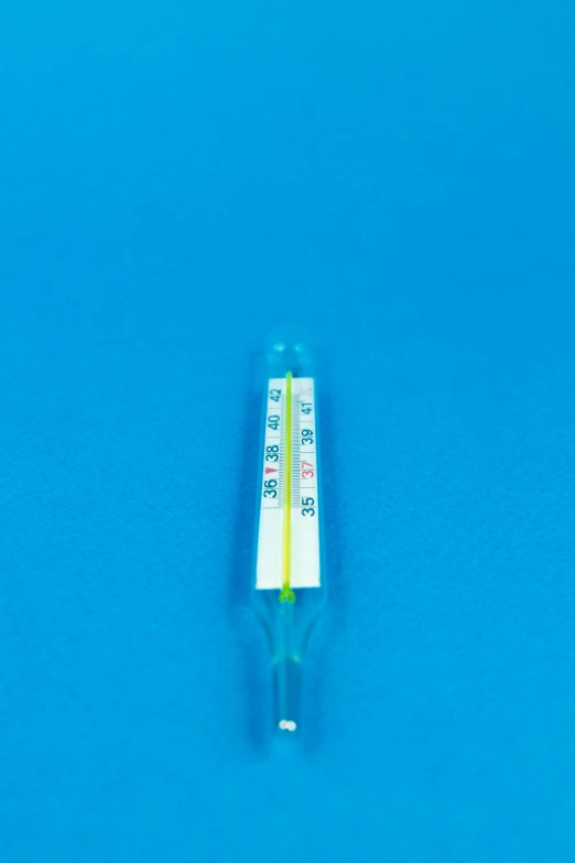 a close up of a light on a blue surface, holding a syringe, hot temperature, yellow, product image