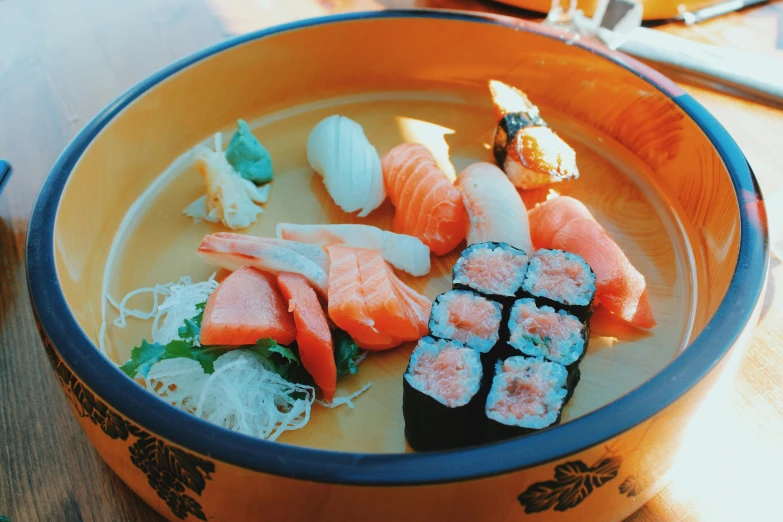 a bowl of sushi sitting on top of a wooden table, bowl filled with food, 🦩🪐🐞👩🏻🦳, thumbnail, nostalgic vibes