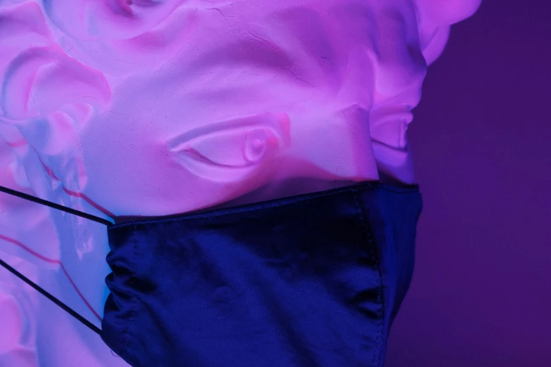 a close up of a mask on a mannequin head, an album cover, unsplash, aestheticism, purple and blue neon, luminescent fabrics, navy, medium gargoyle soft light