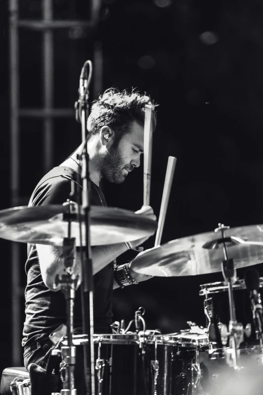 a black and white photo of a man playing drums, liam, profile image, charlie day, details