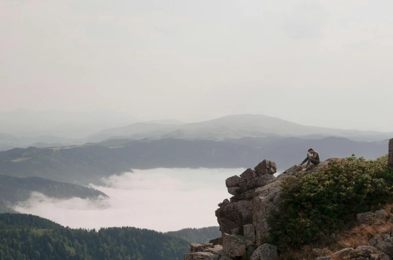 a couple of people sitting on top of a mountain, by Emma Andijewska, pexels contest winner, romanticism, panorama distant view, little fog, ukraine. photography, slide show