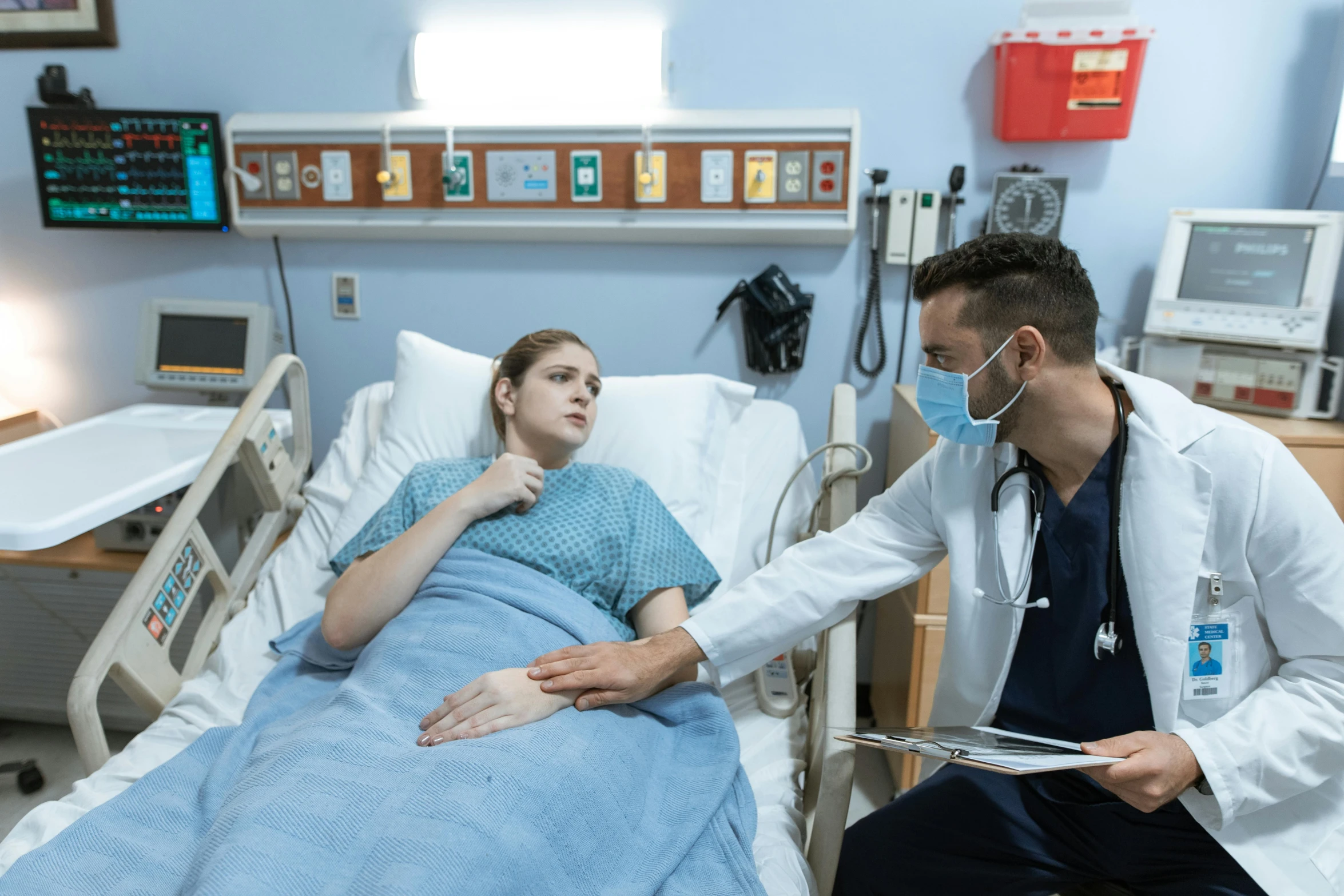 a man sitting next to a woman in a hospital bed, by Meredith Dillman, pexels contest winner, scene from live action movie, surgery theatre, sydney hanson, calmly conversing 8k