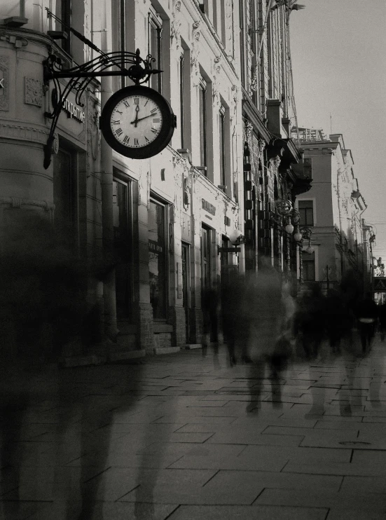 a clock hanging from the side of a building, a black and white photo, by Constantine Andreou, pexels contest winner, conceptual art, people walking down a street, ghosts, late afternoon, in a square