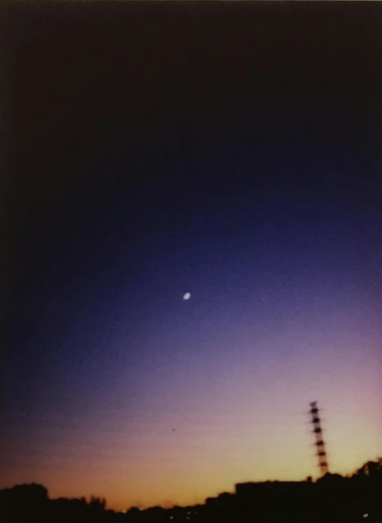 a body of water with a tower in the background, a polaroid photo, by Awataguchi Takamitsu, postminimalism, jupiter moon mars, dusk on jupiter, low quality grainy, cloudless sky