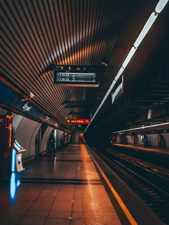 a subway station with a train on the tracks, unsplash contest winner, dystopian lighting, 🚿🗝📝, neon electronic signs, thumbnail