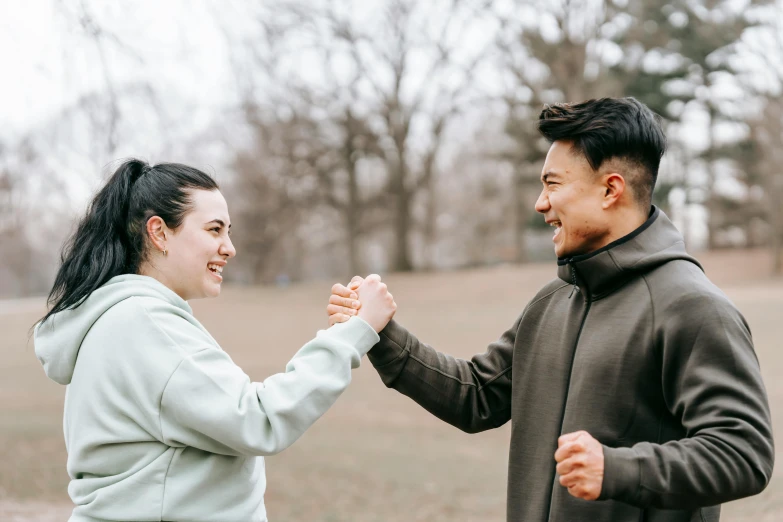 a man and a woman shaking hands in a park, pexels contest winner, happening, pokimane, both laughing, profile image, 1 2 9 7
