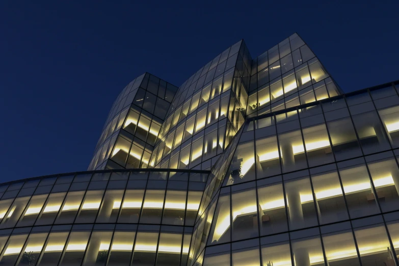 the exterior of a building lit up at night, inspired by Zaha Hadid, unsplash contest winner, library of babel, ny, medical research facility, profile image