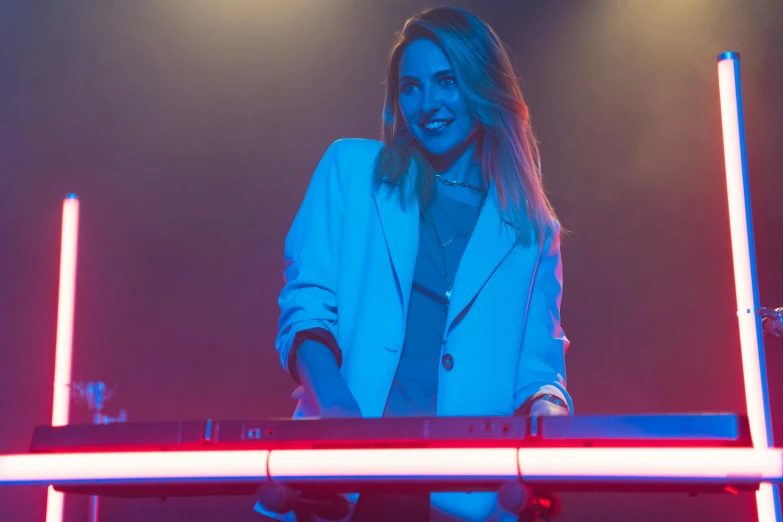 a woman that is standing in front of a keyboard, pretty lights, emma roberts, blue and red lights, kirsi salonen