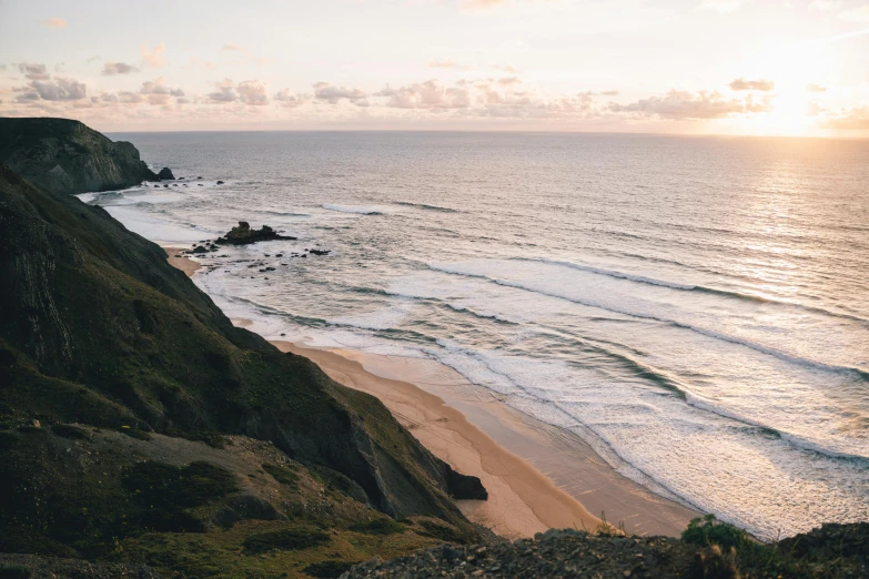 a view of the ocean from the top of a hill, unsplash contest winner, renaissance, on the beach at sunset, australian beach, cornwall, liam brazier