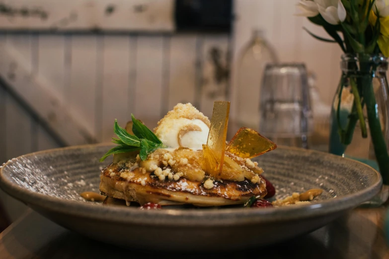 a close up of a plate of food on a table, by Lee Loughridge, dessert, pancake flat head, chef platypus, thumbnail