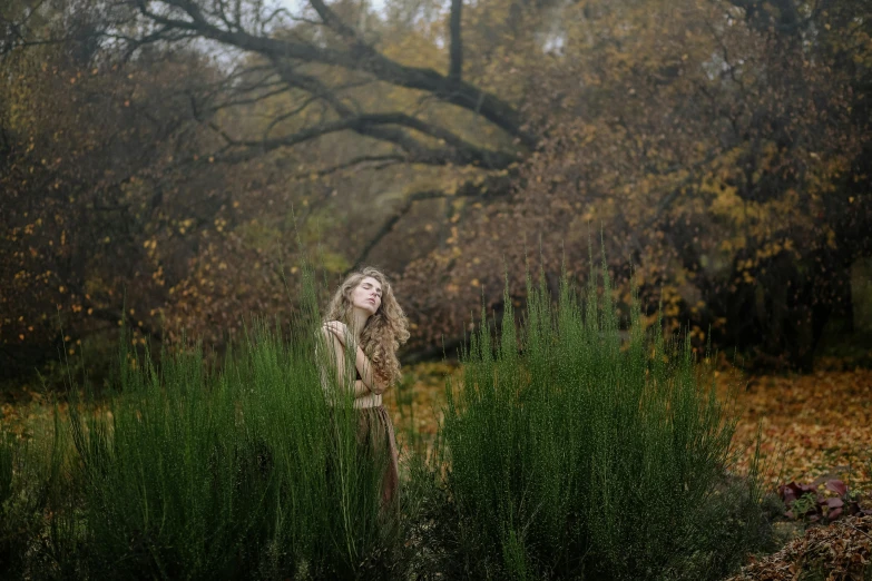 a woman standing in a field of tall grass, a portrait, unsplash, renaissance, dryad in the forest, portrait image, autumn season, ignant