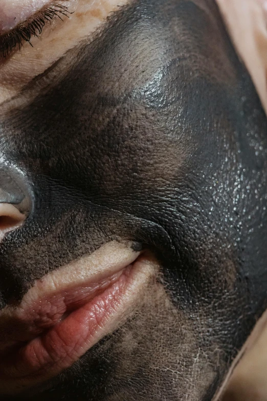 a close up of a person with a black mask on, by Doug Ohlson, reddit, renaissance, mole on cheek, facial muscles, licking out, charcoal color skin