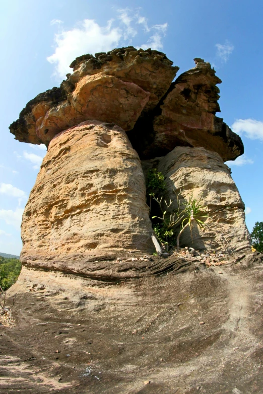 a man riding a skateboard on top of a rock, by Peter Churcher, land art, baobab trees, 3 6 0 panorama, tall big rocks, buttresses