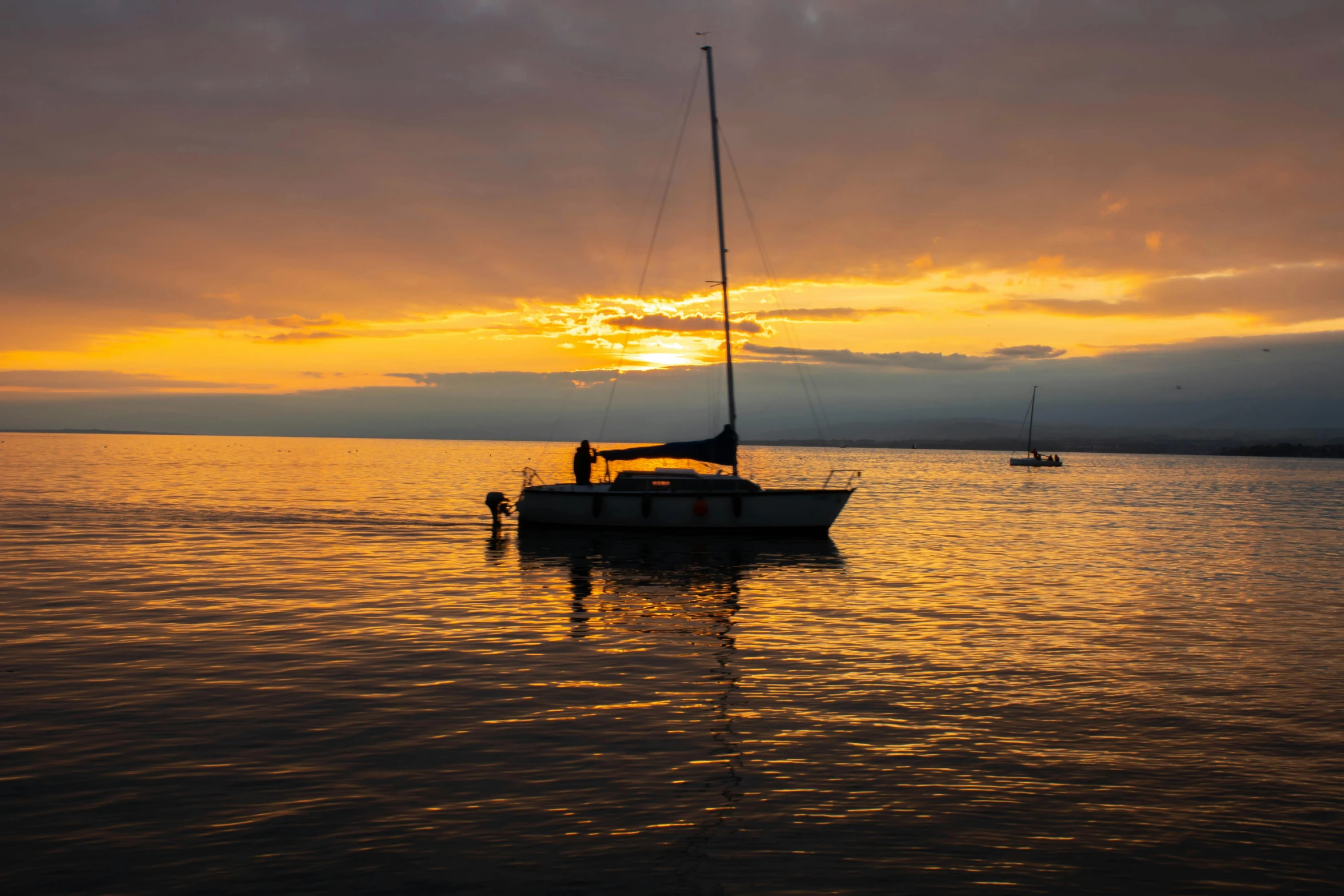 a boat floating on top of a body of water, pexels contest winner, romanticism, sunsetting color, maui, sailboats, slight overcast