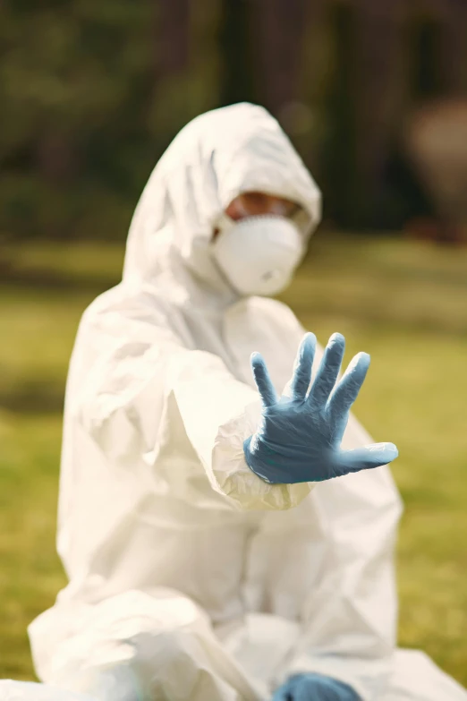 a person in a white suit and blue gloves, covid, wearing a blue hoodie, hands down, synthetic materials