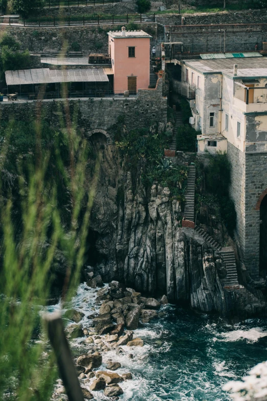 a train traveling over a bridge over a body of water, a picture, inspired by Elsa Bleda, renaissance, cliffside town, cinq terre, waterfall walls, full frame image