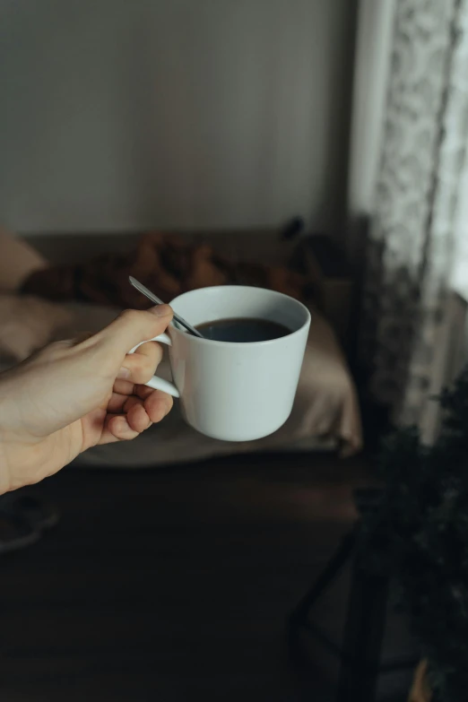 a person holding a cup of coffee in their hand, waking up, secret tea society, multiple stories, grey