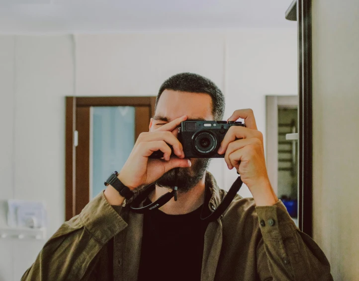 a man taking a picture of himself with a camera, a picture, by Adam Marczyński, pexels contest winner, indoor picture, demna gvasalia, halfbody headshot, low quality photo