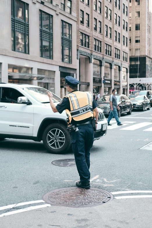 a police officer directing traffic on a busy city street, pexels contest winner, happening, heron preston, in new york, 🚿🗝📝, parking in the street