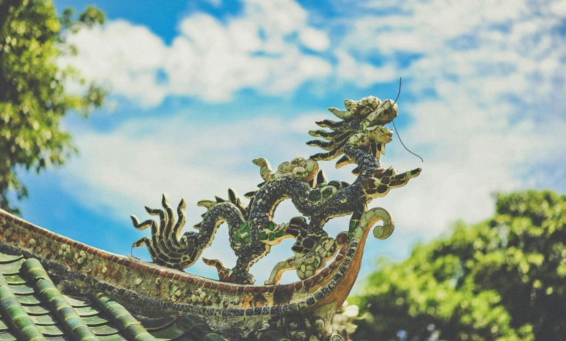 a close up of a roof with a dragon on it, a statue, by Adam Marczyński, pexels contest winner, cloisonnism, cloud in the shape of a dragon, floating chinese lampoons, sea dragon, instagram picture