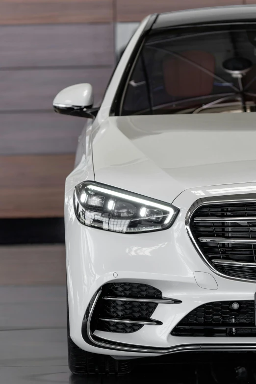a white mercedes s - class parked in a showroom, pexels contest winner, photorealism, front light, glowing oled visor, detail shot, wide angle exterior 2022