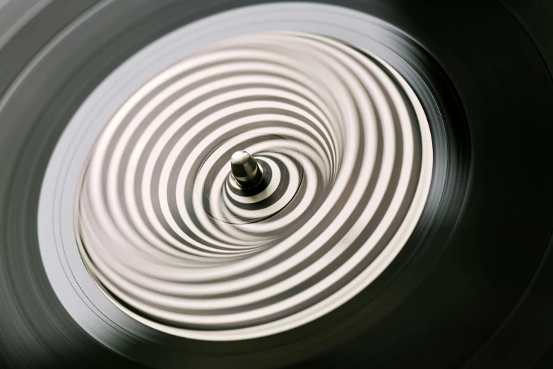 a black and white photo of a spiral, an album cover, inspired by Herbert Bayer, trending on pexels, kinetic art, liquid polished metal, gong, vinyl, hyper realistic detailed render